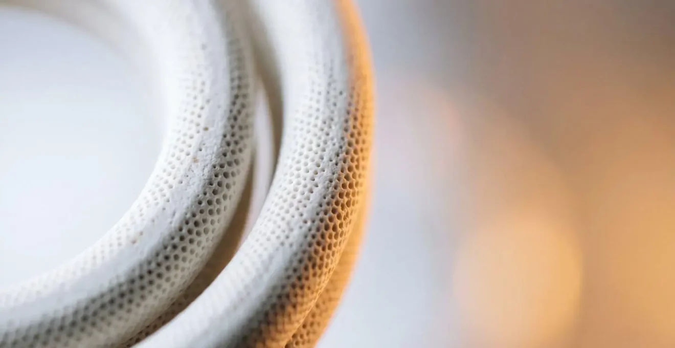 Close-up cross-section view of ceramic coil technology in vaping device showing porous microporous structure and heat distribution