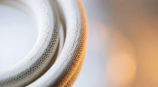 Close-up cross-section view of ceramic coil technology in vaping device showing porous microporous structure and heat distribution