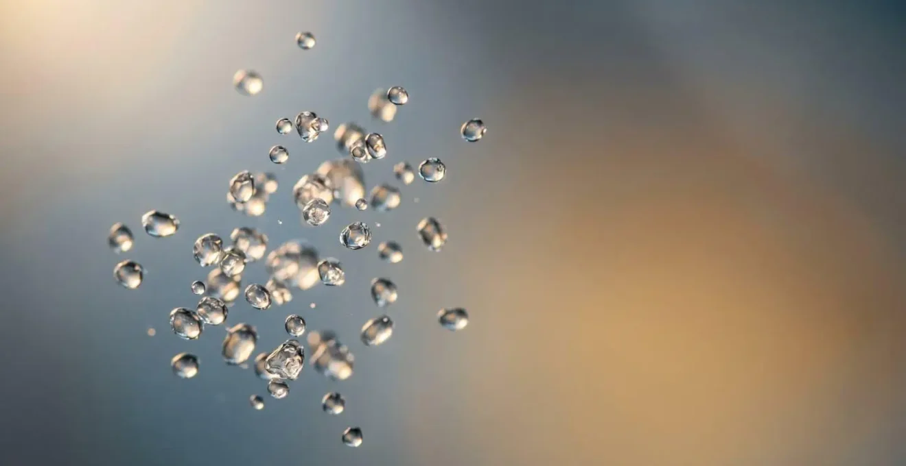 Close-up molecular-inspired composition showing vapor particles and smooth liquid texture representing nicotine salt chemistry