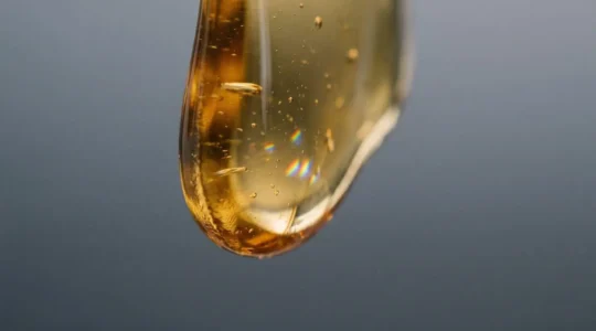 Close-up of thick high-VG e-liquid viscosity affecting vape performance and flavor delivery in pod system
