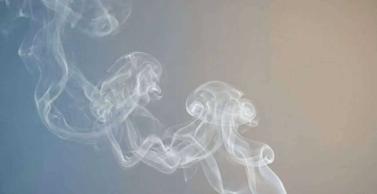 Close-up of vapor clouds from an e-cigarette against a clean minimal background representing nicotine-free vaping